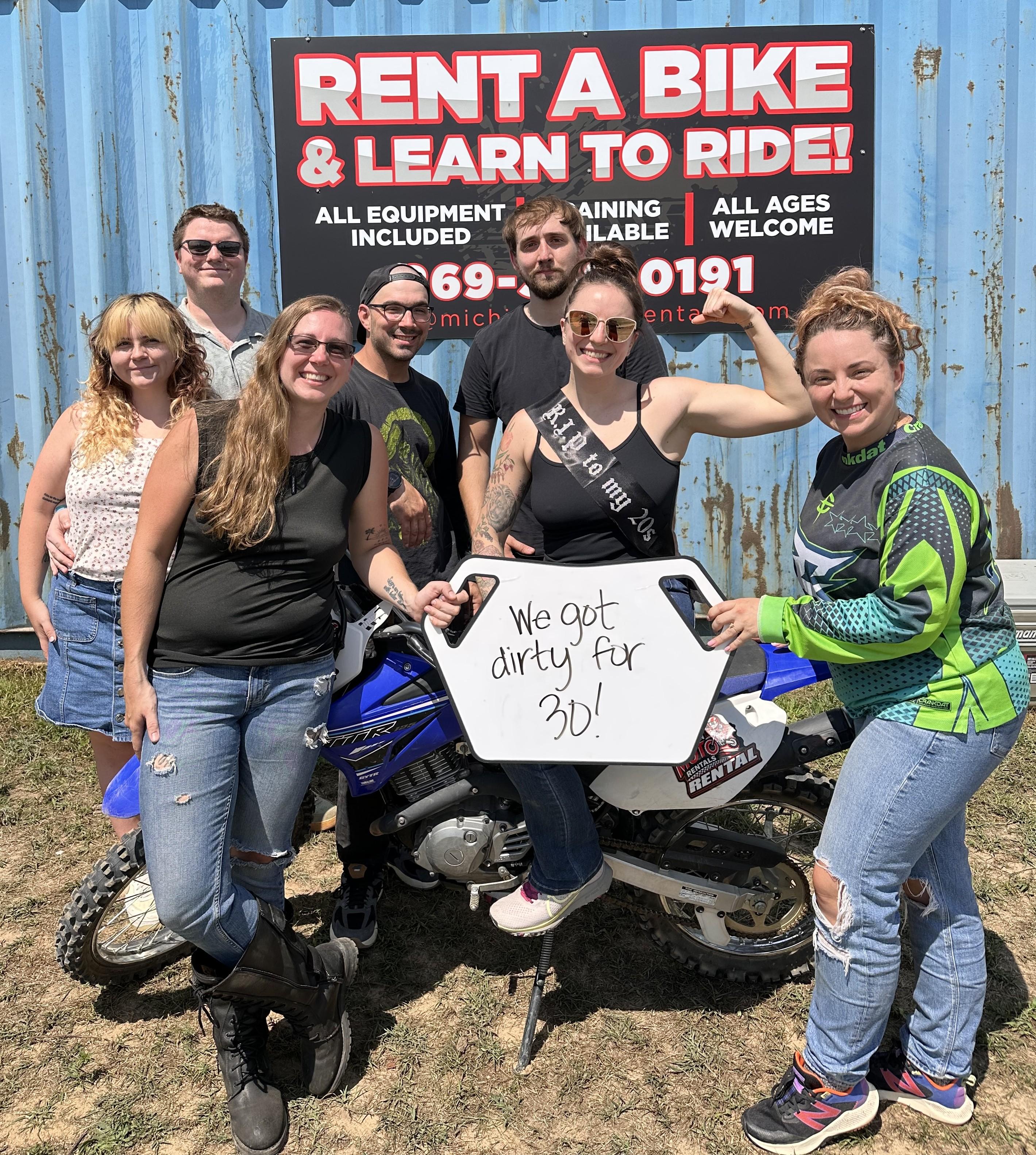 Photo of renter in front of Michigan Moto Rentals sign